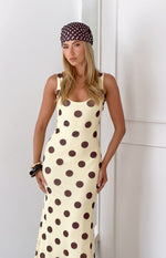 Upper portion of a fitted yellow polka dot maxi dress with a scoop neck and thick straps