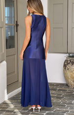 Rear view of a navy maxi dress with a fitted satin bodice and a flowy sheer chiffon skirt, showing the high back and zipper