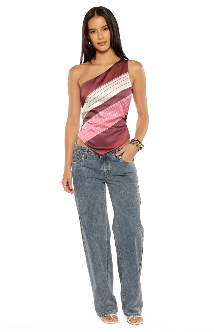 Front view of a pink, white, and burgundy striped one-shoulder satin top with an asymmetric pointed hem