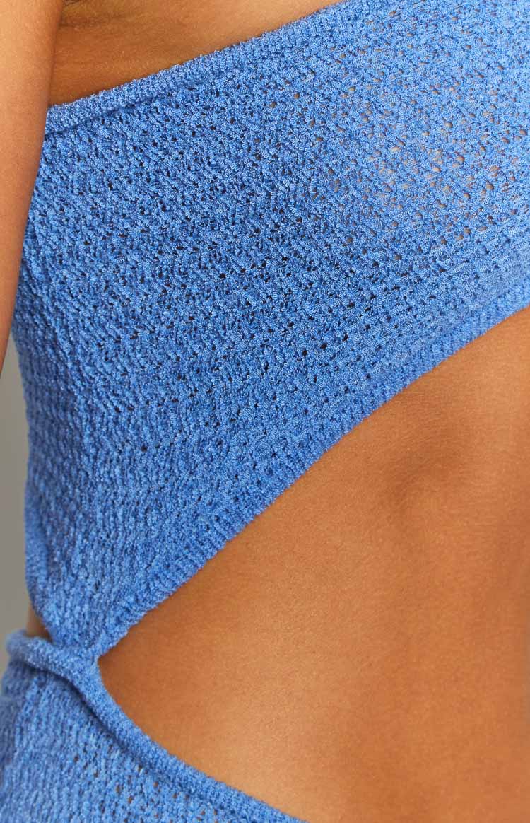 Close-up of the blue knit fabric with a side cutout detail on the maxi dress