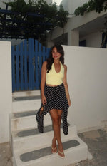 Black polka dot midi skirt with a flowy hanky hem and uneven points