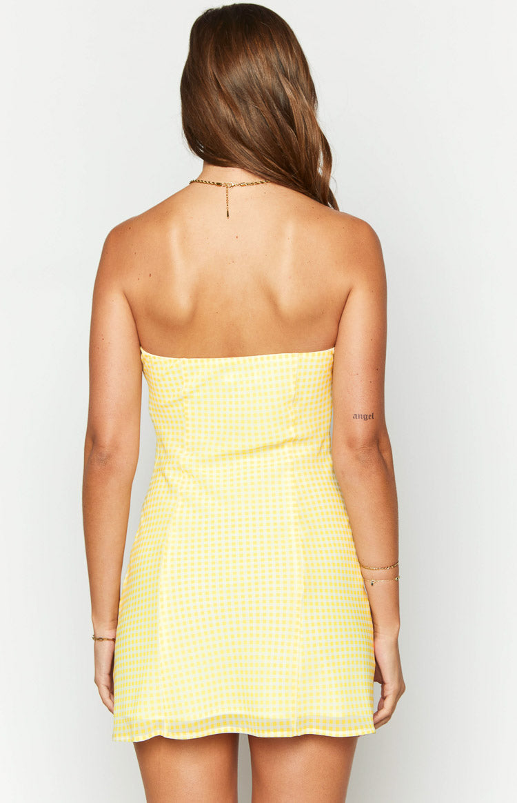 Rear view of the yellow gingham strapless mini dress, showing the fitted bodice and straight hemline