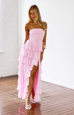 Pink strapless maxi dress with tiered ruffles, a high thigh split, and side lace-up detail