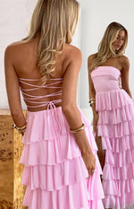 Pink strapless maxi dress with lace-up back, tiered ruffle skirt, and side lacing detail