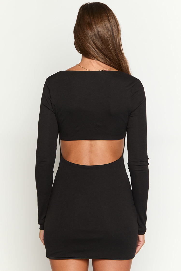 Rear view showing a large back cutout on a black long sleeve mini dress