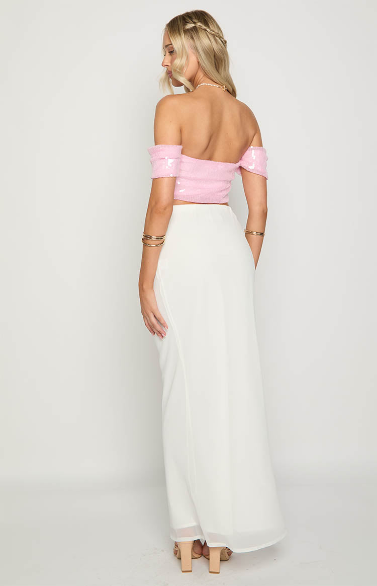 Rear view of a pink sequin off-shoulder crop top with short sleeves