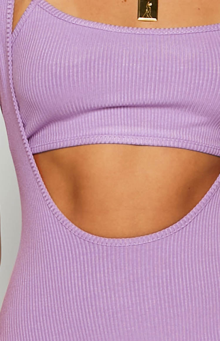 Close-up of the side cutout on a purple ribbed maxi dress, showing the fabric texture and edge stitching