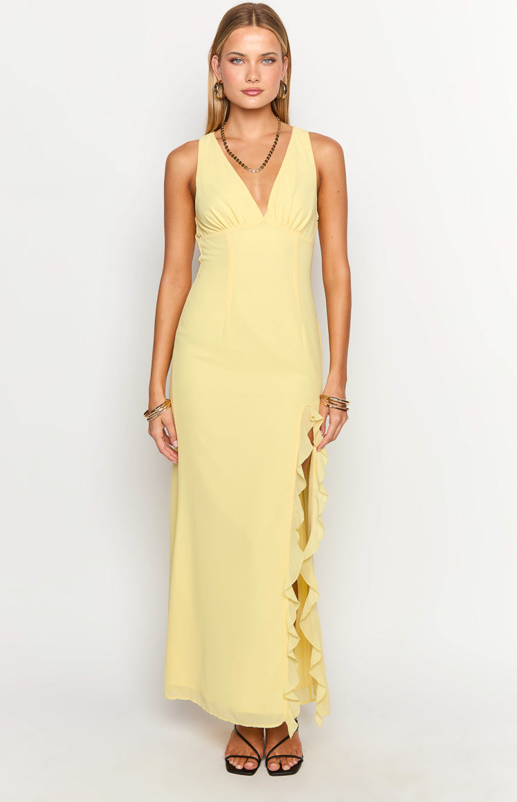 Yellow sleeveless maxi dress with a V-neck, empire waist, and ruffled high leg slit