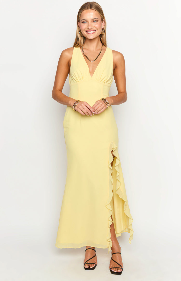 Front view of a yellow V-neck maxi dress with a ruched bodice and ruffled high leg split