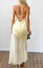 Rear view of a yellow satin maxi dress with a low V-back, criss-cross spaghetti straps, and tie-back detail