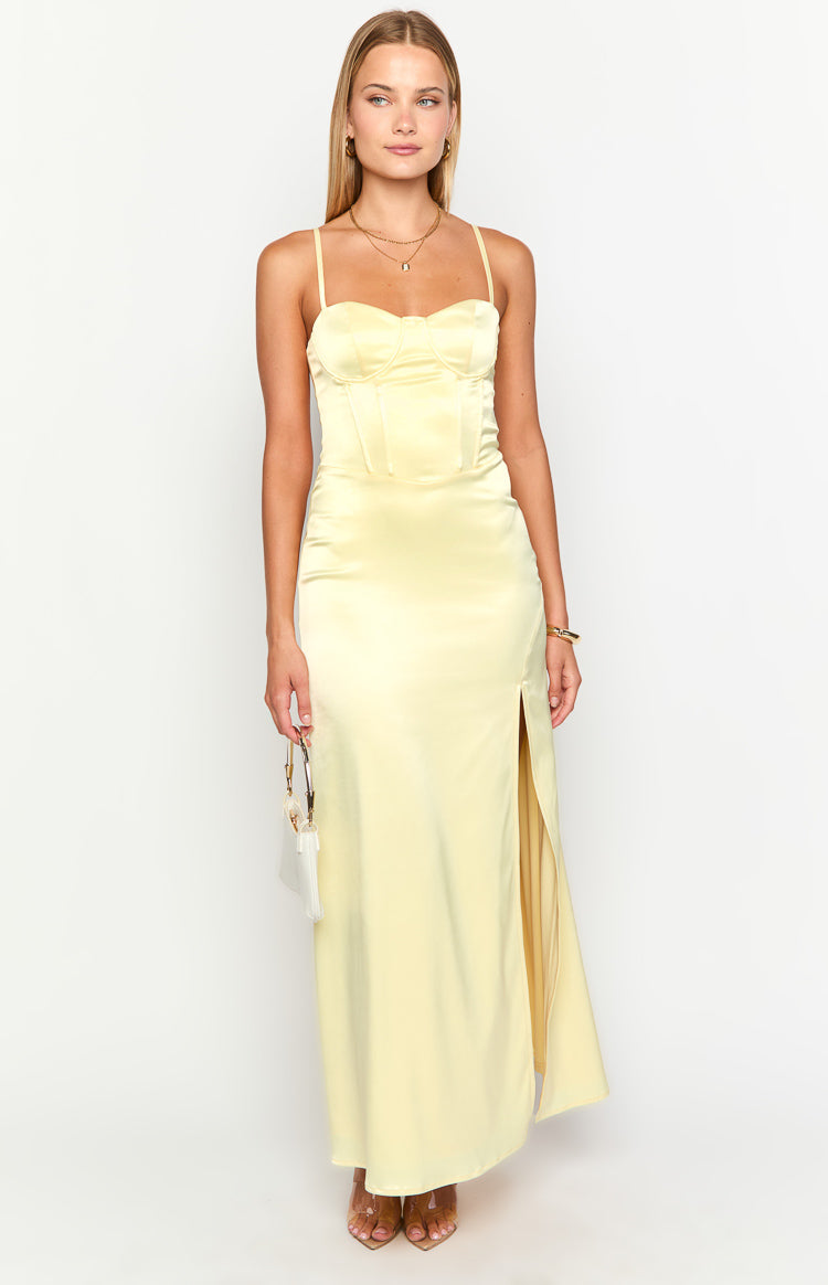 Light yellow satin maxi dress with a sweetheart corset bodice, thin straps, and a high leg slit