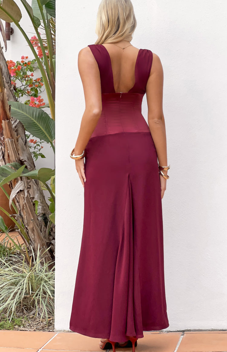 Rear view of a burgundy contrast satin maxi dress with a deep scoop back, back zipper, and flowing skirt with a back pleat