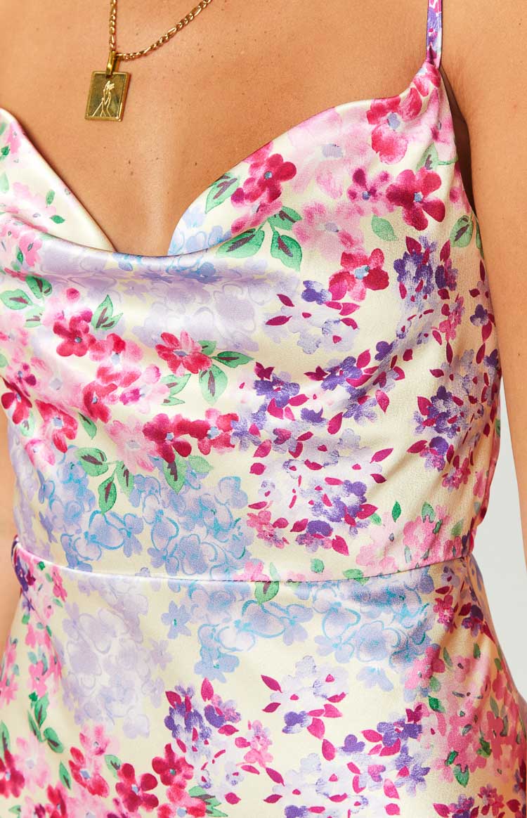 Close-up of the yellow floral print satin cowl neck and defined waist seam of the dress