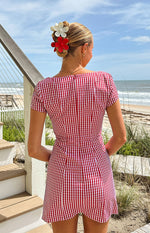 Rear view of a red gingham mini dress with a square back neckline and short puff sleeves