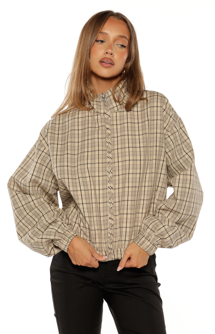 Beige plaid cropped funnel neck jacket with a half-zip, braided front detail, and voluminous elasticated sleeves