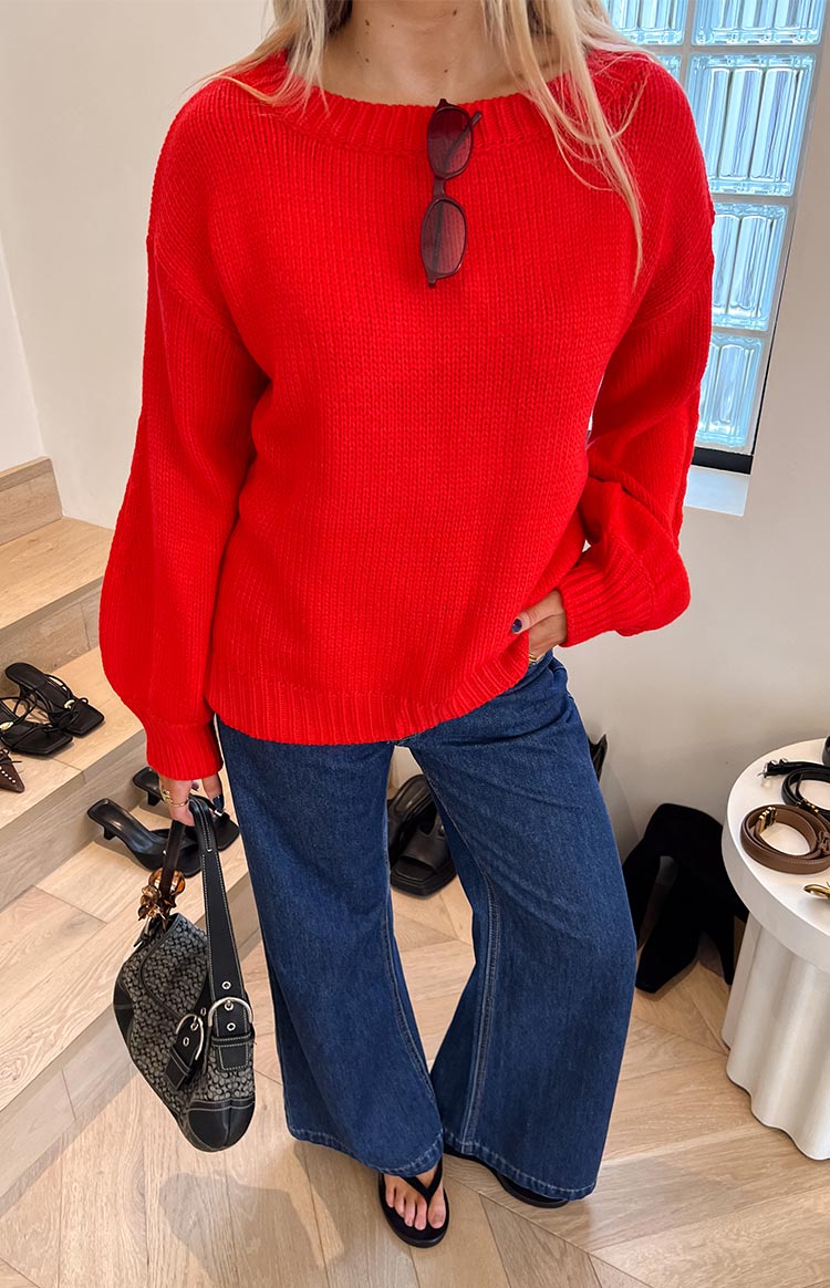 Front view of dark blue denim flare jeans with a wide leg and a pronounced flare from the knee