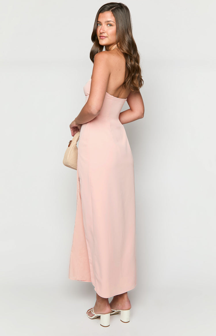 Side view of a pink strapless maxi dress with a fitted bodice and a high side slit