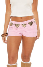 Pink micro shorts with horizontal ruching, a small pink bow at the waist, and delicate lace trim