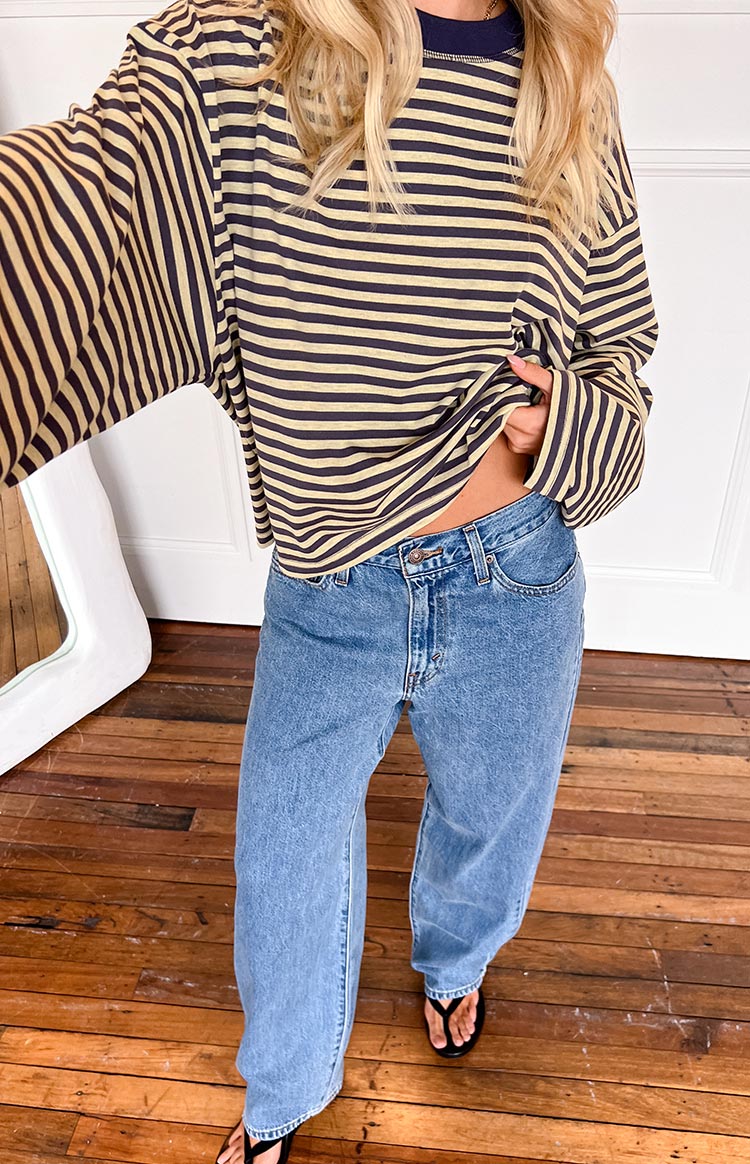 Front view of light wash baggy dad jeans with a relaxed, wide-leg fit and a visible button and zipper fly