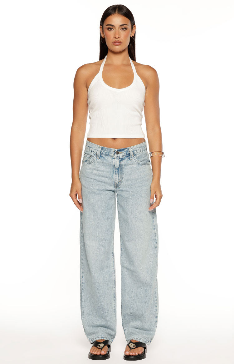 Light wash blue baggy dad jeans with a relaxed wide-leg fit and classic five-pocket styling
