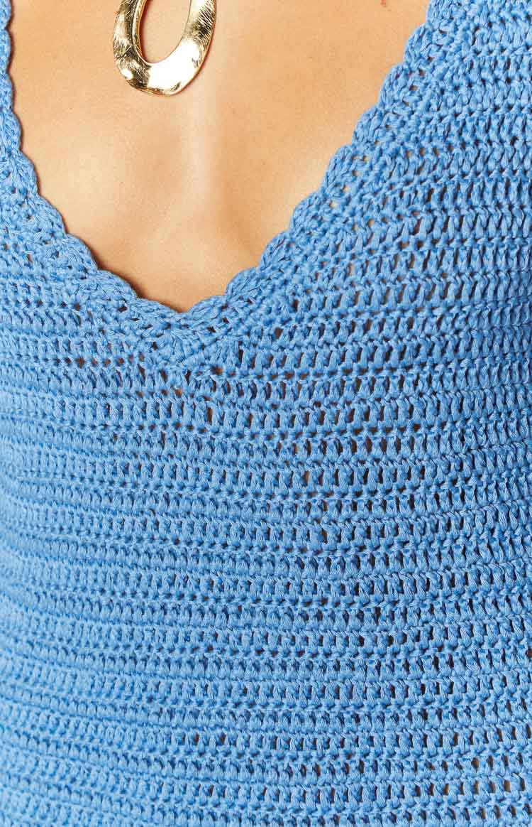 Detail shot of the blue crochet mini dress showing the scalloped V-neck and open weave texture