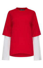 Front view of a crimson red short sleeve shirt layered over a white long sleeve shirt with a mock neck