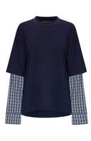 Beginning Boutique Lioness Bottega Navy Layered Contrast Sleeve Shirt — navy oversized crew neck shirt with blue plaid long sleeves and an asymmetrical cropped hem