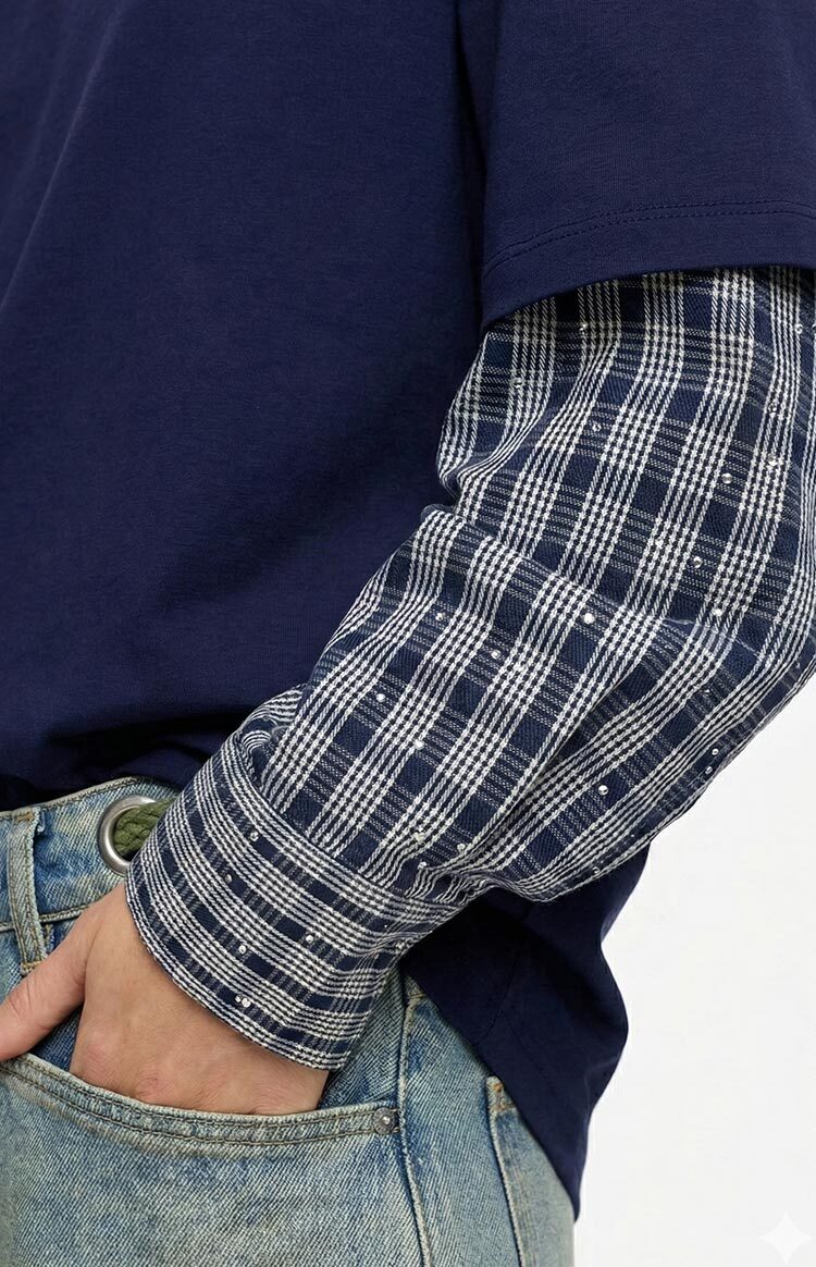 Close-up of the navy layered sleeve with a plaid inner layer featuring silver studs