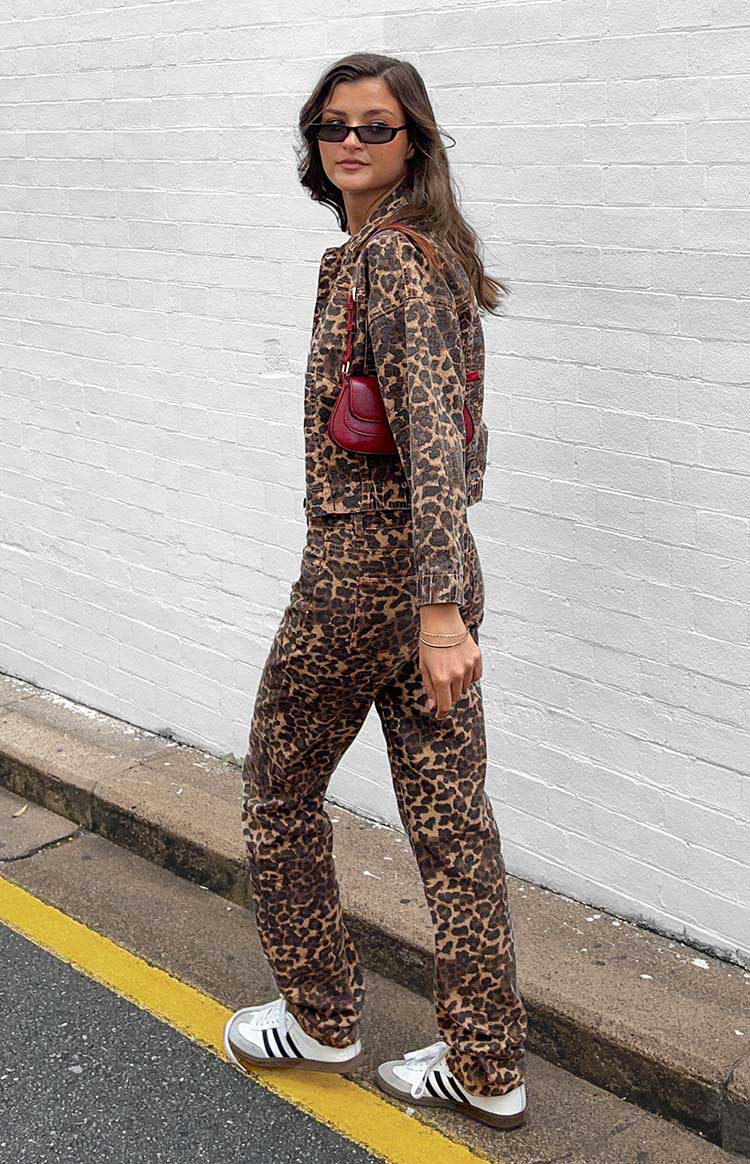 Side view of the full length brown and black leopard print straight leg jeans