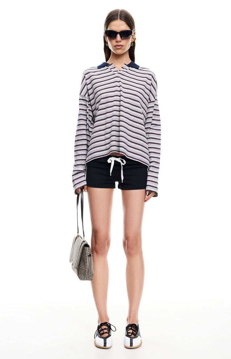 Front view of black relaxed fit shorts with a prominent white drawstring at the waist