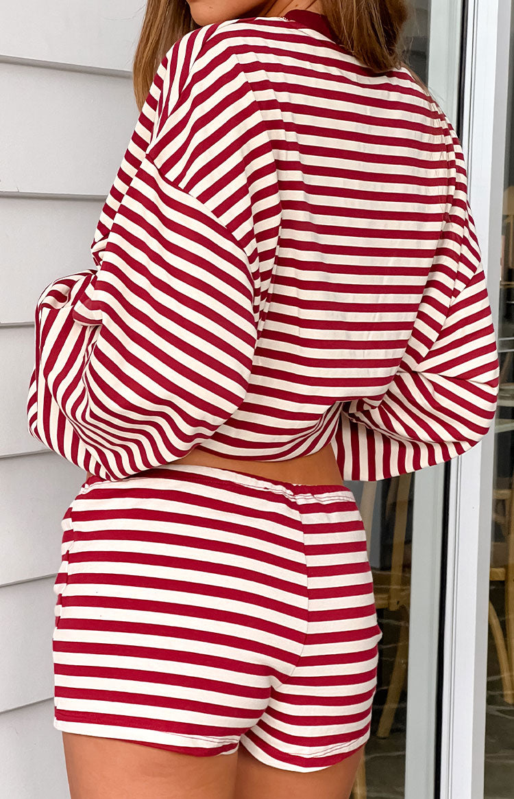 The back view of fitted short shorts featuring horizontal red and white stripes and an elastic waistband.