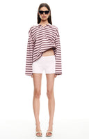 Our oversized pink knit polo sweater with dark maroon horizontal stripes and a pink collar featuring a split neckline.
