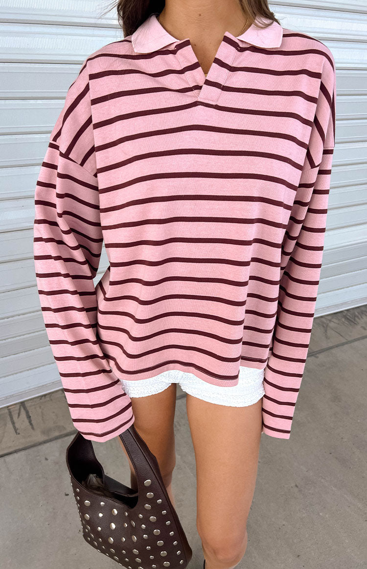 Our oversized pink knit polo sweater with dark maroon horizontal stripes and a pink collar featuring a split neckline.