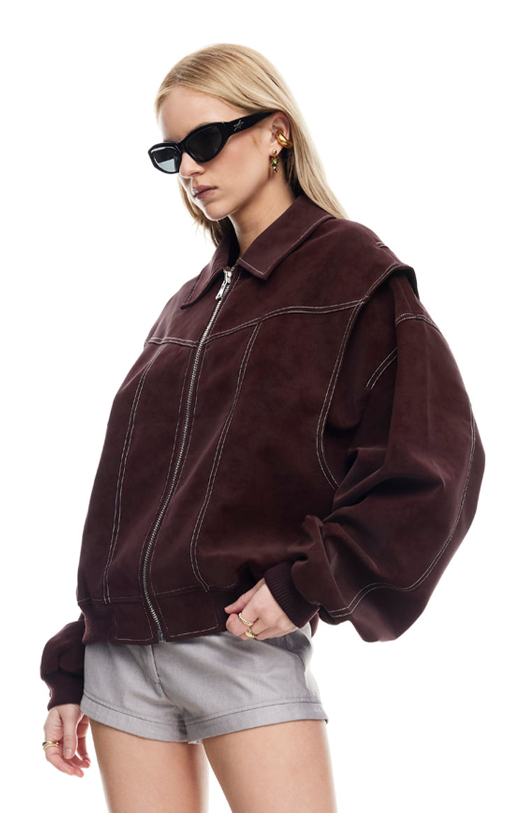 Close-up of the shiraz suede-like bomber jacket with white contrast stitching and dropped shoulder