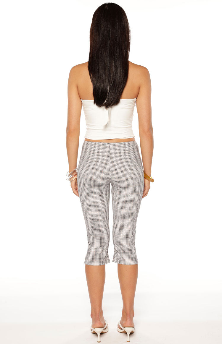 Rear view of the moonlight plaid capri pants, showing the fitted silhouette and button details at the outer hem