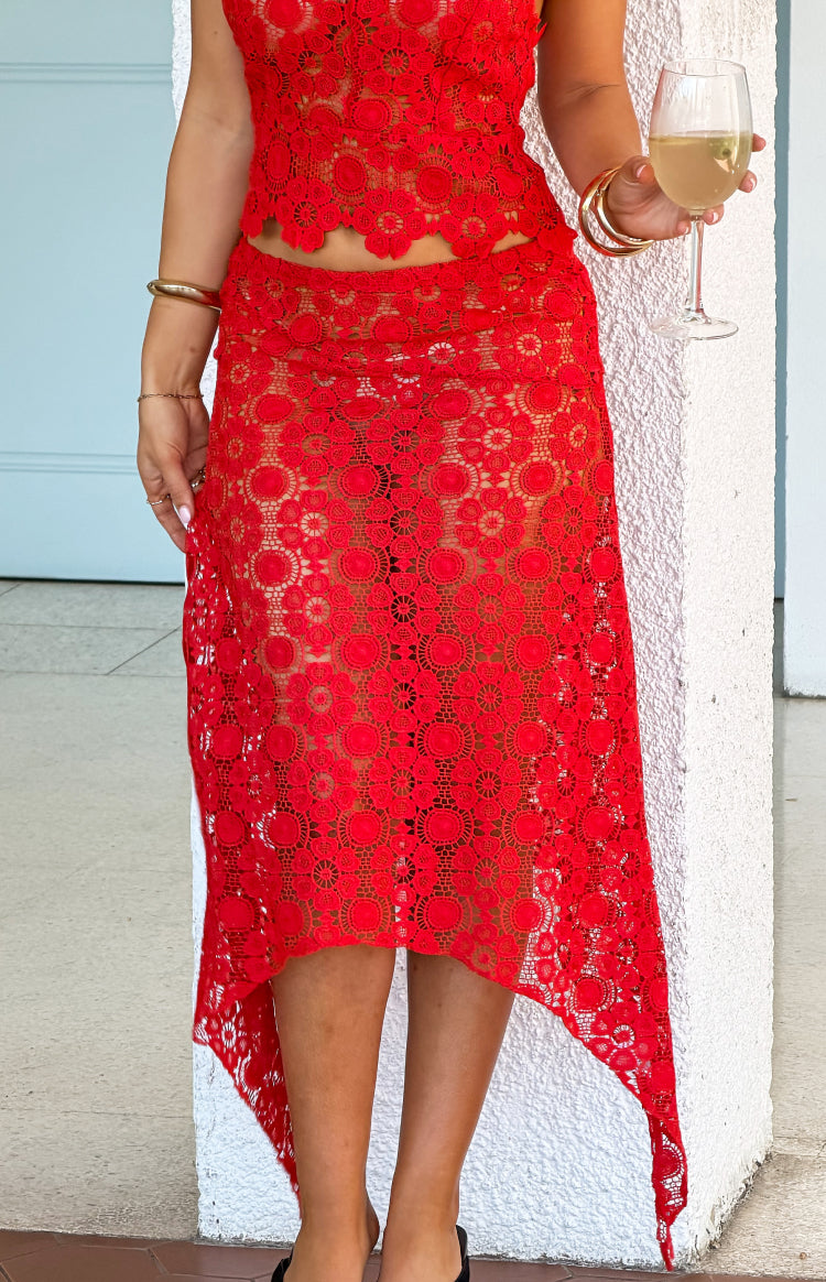 Rouge crochet midi skirt with intricate circular patterns and an asymmetrical handkerchief hem