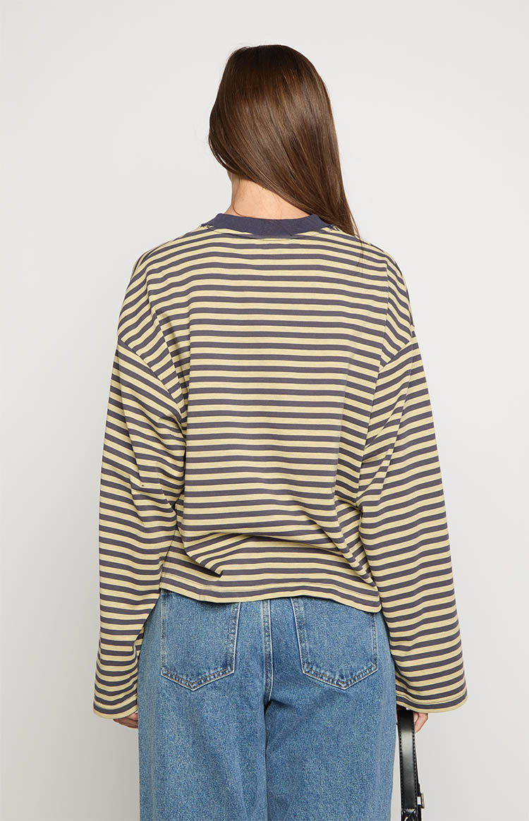 Rear view of a beige and dark striped long sleeve top with a relaxed fit and dark crew neck trim