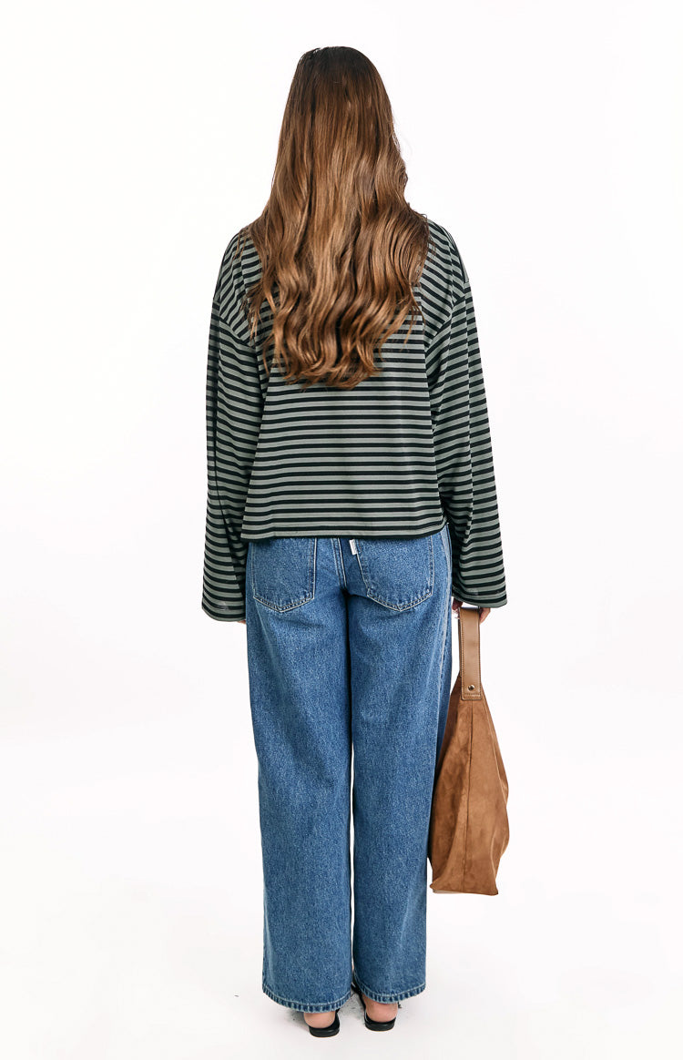 Rear view of a forest green and black striped long sleeve top with a relaxed fit