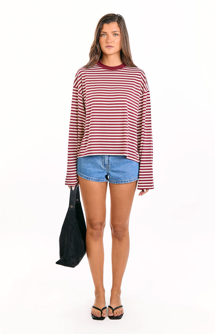 Full front view of a wine red and white striped long sleeve top with a relaxed fit and crew neck