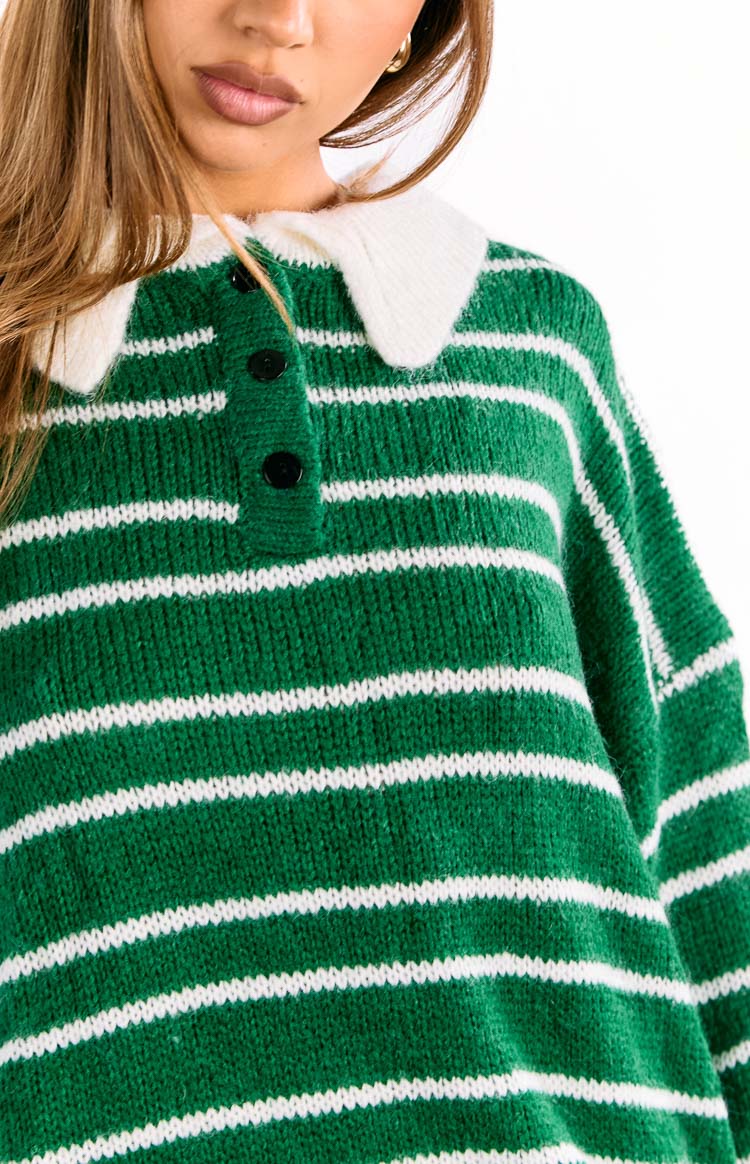 Close-up of the white collar and black button placket on a forest green and white striped knit jersey