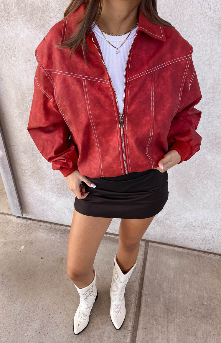 Crimson red bomber jacket with white contrast stitching, a full zip front, and ribbed cuffs and hem