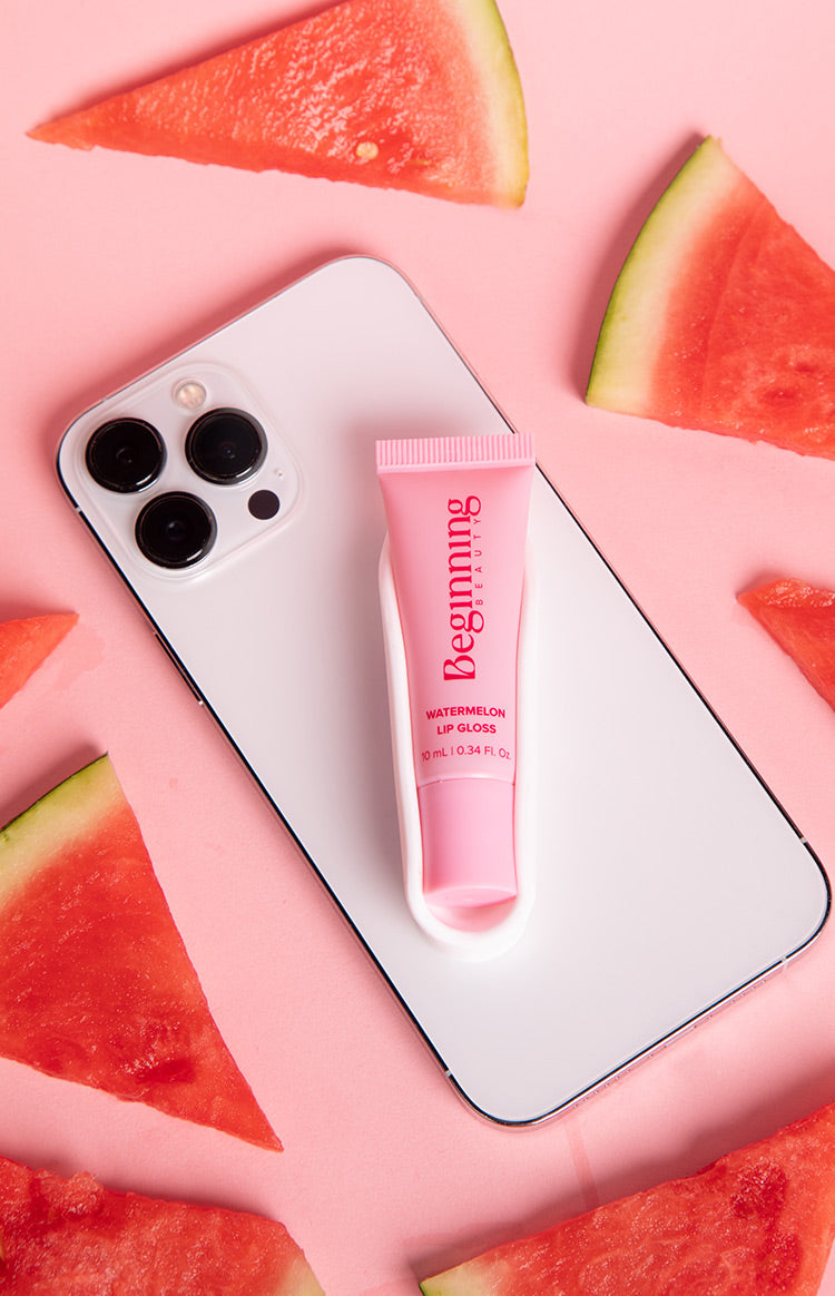 White phone holder on the back of a phone, designed to securely hold a pink lip gloss tube