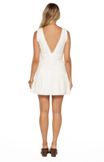 Rear view of a white cotton mini dress with a deep V-back, broderie lace bodice, and gathered skirt