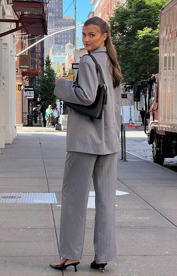 Rear view of grey pinstripe wide-leg pants with a relaxed fit and straight cut