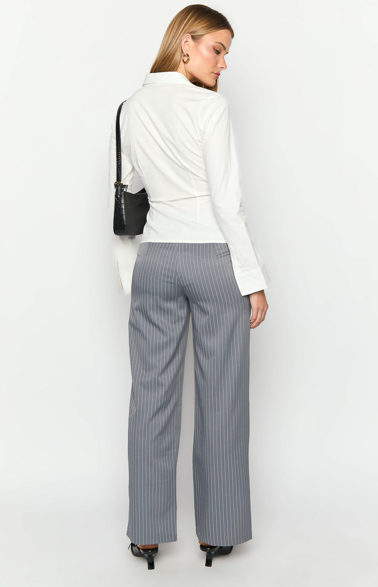 Rear view of full-length grey wide-leg pants with vertical white pinstripes