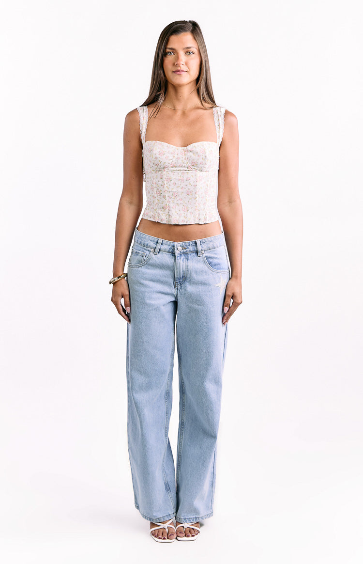 Front view of a white floral corset top featuring a sweetheart neckline and delicate lace-trimmed straps