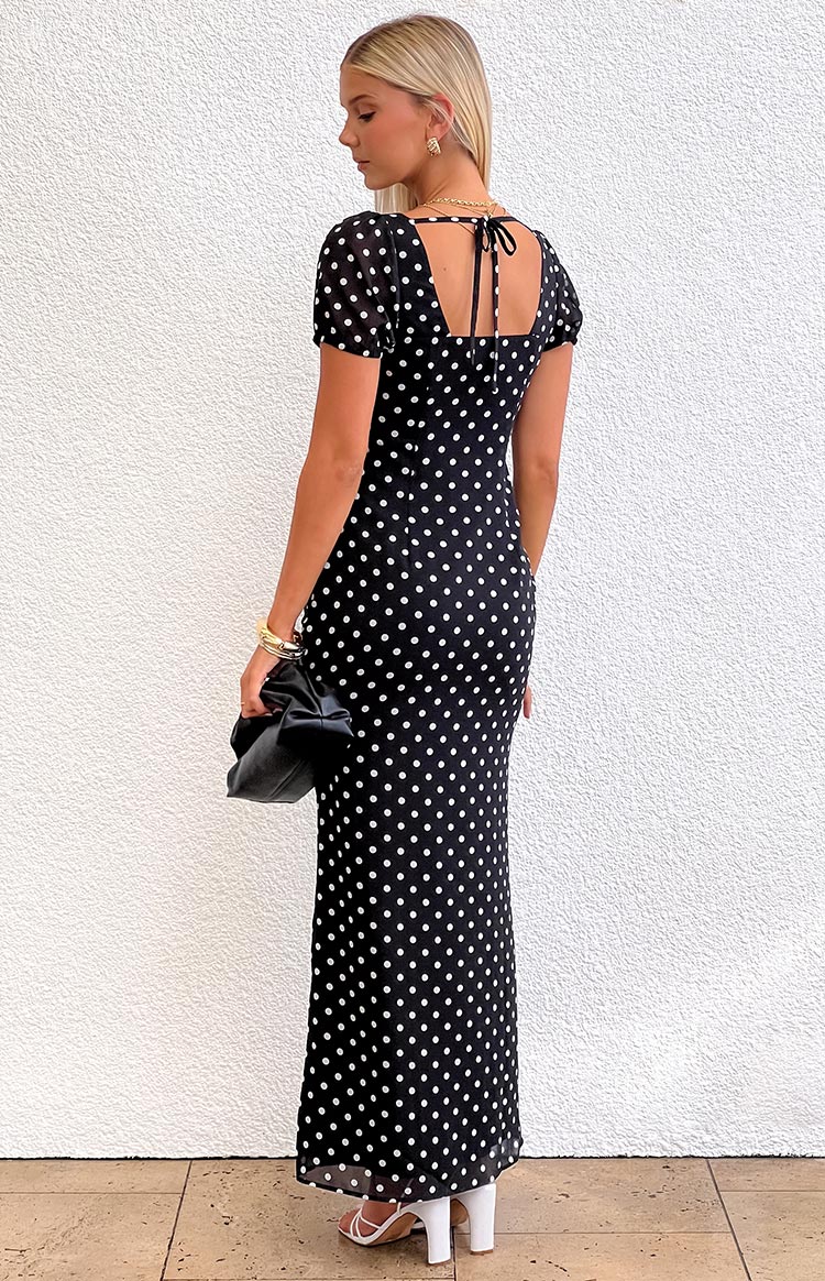 Rear view of a black polka dot maxi dress with a square back neckline and tie-back detail