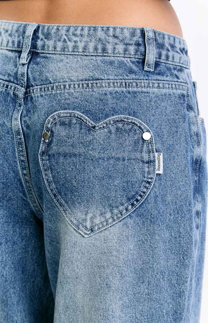 Beginning Boutique Lovers Lane Mid Wash Denim Heart Pocket Slouchy Jeans mid wash denim slouchy jeans with a heart-shaped back pocket and small brand tag
