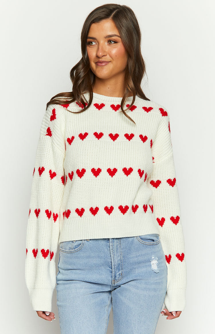 Cream knit jumper with red heart pattern in horizontal stripes and a crew neck