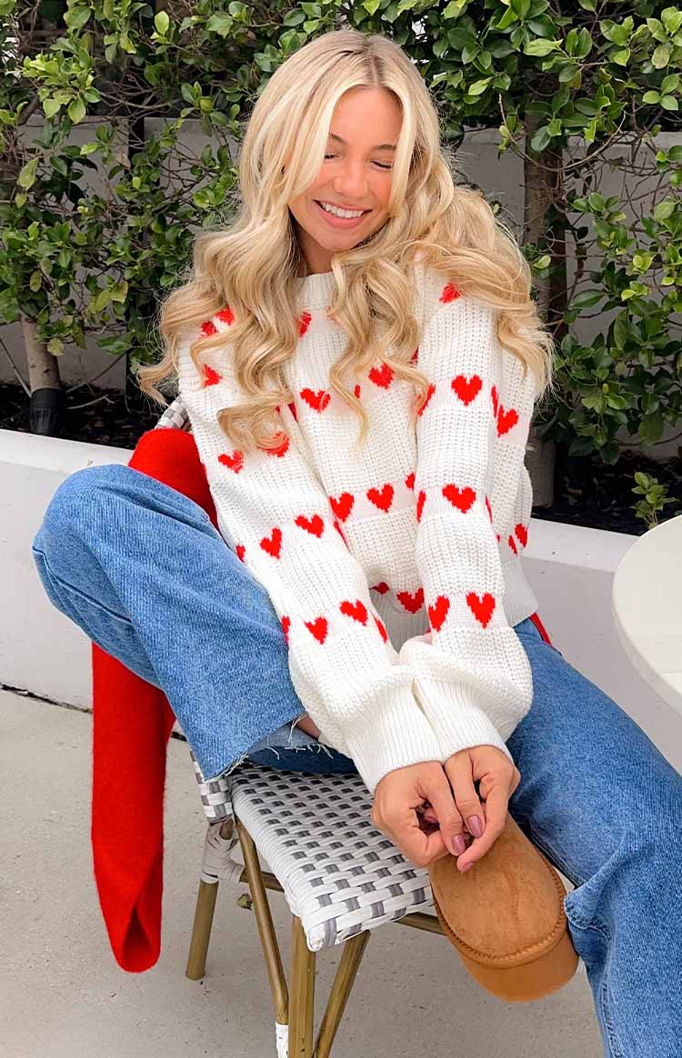 Relaxed fit white knit jumper with red heart pattern and long ribbed cuffs